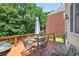Outdoor deck with table, chairs and grill nestled amongst lush greenery at 2002 Ivy Ridge Se Rd, Smyrna, GA 30080