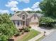 Stately brick home with manicured lawn, mature trees, and a welcoming two-car garage in a desirable neighborhood at 2002 Ivy Ridge Se Rd, Smyrna, GA 30080