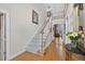 Welcoming foyer featuring a staircase, hardwood floors, and elegant decor that creates a grand entrance at 2002 Ivy Ridge Se Rd, Smyrna, GA 30080