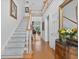 Bright foyer with hardwood floors, staircase, and high ceilings leading to the home's living spaces at 2002 Ivy Ridge Se Rd, Smyrna, GA 30080