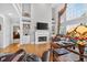 Bright living room featuring a fireplace, built-in shelving, and a large window at 2002 Ivy Ridge Se Rd, Smyrna, GA 30080