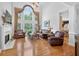 Bright and airy living room with hardwood floors, a fireplace, and large windows offering natural light at 2002 Ivy Ridge Se Rd, Smyrna, GA 30080