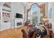 Bright living room with hardwood floors, a fireplace, built-in shelving, and large windows at 2002 Ivy Ridge Se Rd, Smyrna, GA 30080