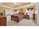 Bright main bedroom with king bed, wood furniture, and ample natural light at 2002 Ivy Ridge Se Rd, Smyrna, GA 30080