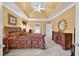 Large main bedroom features a king-size bed, wooden furniture, and tray ceilings at 2002 Ivy Ridge Se Rd, Smyrna, GA 30080