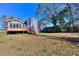 Spacious backyard featuring a deck, mature trees, and a shed on the property; view of the rear of the house at 4185 Duesenberg Dr, Tucker, GA 30084