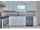 Updated kitchen featuring stainless steel appliances, granite countertops and white cabinets at 4185 Duesenberg Dr, Tucker, GA 30084