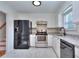 Updated kitchen with stainless steel appliances, white cabinets, and granite countertops at 4185 Duesenberg Dr, Tucker, GA 30084