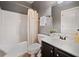 Cozy bathroom featuring a shower-tub combo and a dark wood vanity with white countertop at 4465 Saint Andrews Crest Dr, Cumming, GA 30040