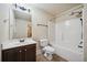 Neutral bathroom features a vanity with dark wood, a combined tub and shower, and tile flooring at 4465 Saint Andrews Crest Dr, Cumming, GA 30040