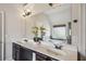 Bright bathroom featuring double sinks, modern fixtures, and a large mirror reflecting a luxurious soaking tub at 4465 Saint Andrews Crest Dr, Cumming, GA 30040