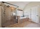 Bathroom featuring a glass-enclosed shower and separate soaking tub at 4465 Saint Andrews Crest Dr, Cumming, GA 30040