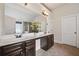 Bathroom with double sinks, dark wood cabinets, and ample counter space at 4465 Saint Andrews Crest Dr, Cumming, GA 30040