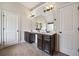 Bathroom with double sinks, dark wood cabinets, and ample counter space at 4465 Saint Andrews Crest Dr, Cumming, GA 30040