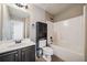 Compact bathroom offers a vanity with dark cabinetry, and a combination tub and shower at 4465 Saint Andrews Crest Dr, Cumming, GA 30040