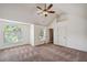 Spacious carpeted bedroom with a ceiling fan, large windows, and ample natural light at 4465 Saint Andrews Crest Dr, Cumming, GA 30040