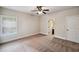 Neutral-toned bedroom with a ceiling fan, window with blinds, and plush carpet at 4465 Saint Andrews Crest Dr, Cumming, GA 30040