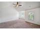 Bright bedroom features neutral carpet, a ceiling fan, and large windows for natural light at 4465 Saint Andrews Crest Dr, Cumming, GA 30040
