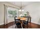 Cozy dining area with hardwood floors, large window, chandelier, and a round table at 4465 Saint Andrews Crest Dr, Cumming, GA 30040