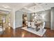 Formal dining room with coffered ceilings, hardwood floors, and stylish chandelier at 4465 Saint Andrews Crest Dr, Cumming, GA 30040