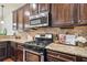 Gourmet kitchen showcasing granite countertops, stainless steel appliances, and backsplash for a perfect cooking experience at 4465 Saint Andrews Crest Dr, Cumming, GA 30040