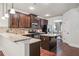 Modern kitchen featuring granite countertops, stainless appliances, dark wood cabinetry and a center island at 4465 Saint Andrews Crest Dr, Cumming, GA 30040