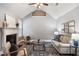 Stylish living room with a fireplace, vaulted ceiling, and comfortable seating arrangement at 4465 Saint Andrews Crest Dr, Cumming, GA 30040