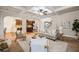 Bright living room boasts stylish furniture, coffered ceiling, and an open layout to the kitchen and staircase at 4465 Saint Andrews Crest Dr, Cumming, GA 30040