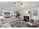 Open-concept living room flows into the primary bedroom with a fireplace and ample natural light at 4465 Saint Andrews Crest Dr, Cumming, GA 30040