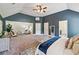 Large main bedroom suite with a sitting area, neutral carpet, and modern decor at 4465 Saint Andrews Crest Dr, Cumming, GA 30040