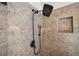 Modern shower featuring decorative tile surround, a niche, and sleek black rainfall shower head and hand sprayer at 4465 Saint Andrews Crest Dr, Cumming, GA 30040