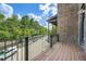 This outdoor balcony has wood floors, a metal railing, and a beautiful view of the street at 504 E Howard Ave, Decatur, GA 30030