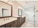 Elegant primary bathroom featuring double vanity, a glass-enclosed shower, and a soaking tub at 504 E Howard Ave, Decatur, GA 30030