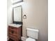 Modern powder room featuring wood cabinet vanity with white sink and modern fixtures at 504 E Howard Ave, Decatur, GA 30030