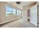 Bright bedroom featuring three large windows, neutral walls, and carpet flooring at 504 E Howard Ave, Decatur, GA 30030