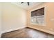 Well lit bedroom with hardwood floors, window with blinds, and neutral wall color at 504 E Howard Ave, Decatur, GA 30030