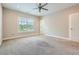 Spacious carpeted bedroom with a ceiling fan and large windows offering plenty of natural light at 504 E Howard Ave, Decatur, GA 30030