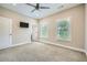 Spacious carpeted bedroom with ceiling fan, neutral color palette, and shuttered windows at 504 E Howard Ave, Decatur, GA 30030