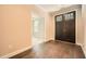 Elegant entryway featuring dark hardwood floors, double doors and view to the living room at 504 E Howard Ave, Decatur, GA 30030