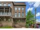 Gorgeous brick townhouse with a covered porch, balcony, and manicured landscaping at 504 E Howard Ave, Decatur, GA 30030