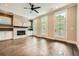 Spacious living room with hardwood floors, a fireplace, and abundant natural light at 504 E Howard Ave, Decatur, GA 30030