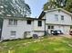 View of the home's back exterior featuring a white painted brick and vinyl siding at 5347 Ocarol Ct, Stone Mountain, GA 30088