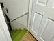 Basement stairs with bright green carpet and painted white walls at 5347 Ocarol Ct, Stone Mountain, GA 30088