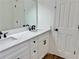 Bathroom featuring a double sink vanity with granite countertops, white cabinets and black hardware at 5347 Ocarol Ct, Stone Mountain, GA 30088
