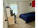 Bedroom featuring neutral colored carpet, a blue bed, and a closet in the background at 5347 Ocarol Ct, Stone Mountain, GA 30088