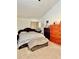 Spacious bedroom featuring neutral colored carpet, a large bed and a dresser at 5347 Ocarol Ct, Stone Mountain, GA 30088