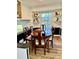 Elegant dining room with a wooden table set by a large window, bathed in natural light at 5347 Ocarol Ct, Stone Mountain, GA 30088
