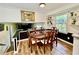 Charming dining room with a hardwood floor and wooden table set near a bright window at 5347 Ocarol Ct, Stone Mountain, GA 30088