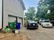 Driveway featuring parked cars, trash and recycle bins and a view of the side of the home at 5347 Ocarol Ct, Stone Mountain, GA 30088