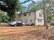Back exterior view of a home featuring white painted brick and siding and ample parking space at 5347 Ocarol Ct, Stone Mountain, GA 30088